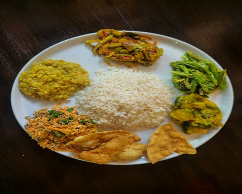 A plate of traditional rice, dal, and vegetables